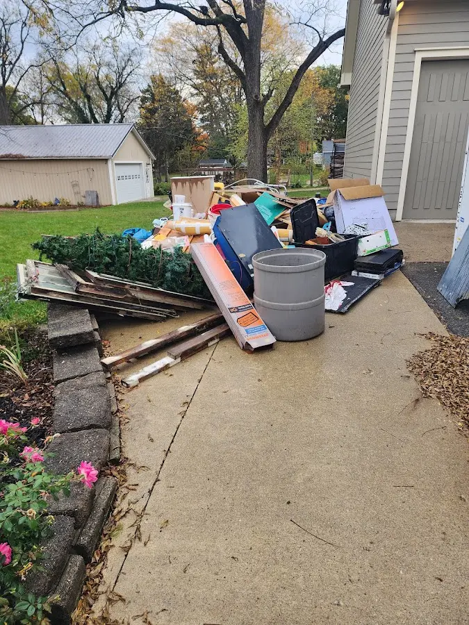 Dumpster being loaded with debris for 12 Yard Dumpster Rental in Stow